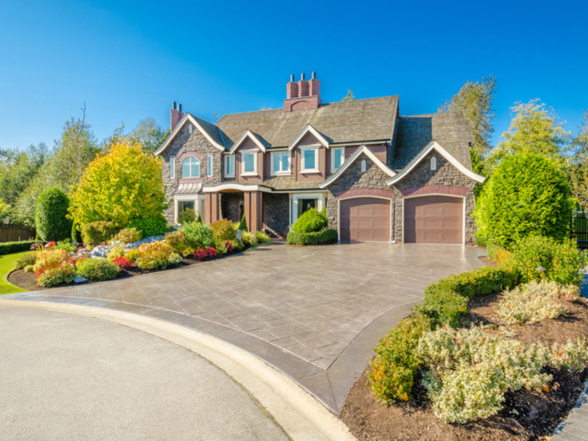 A large luxury suburban house in British Columbia, showcasing the type of property that influences how much is house insurance in BC.