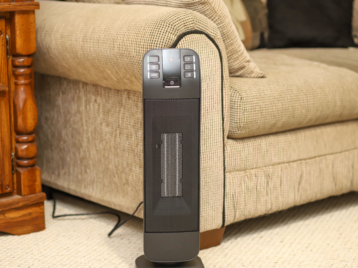 Electric space heater standing on carpet in a residential seating area
