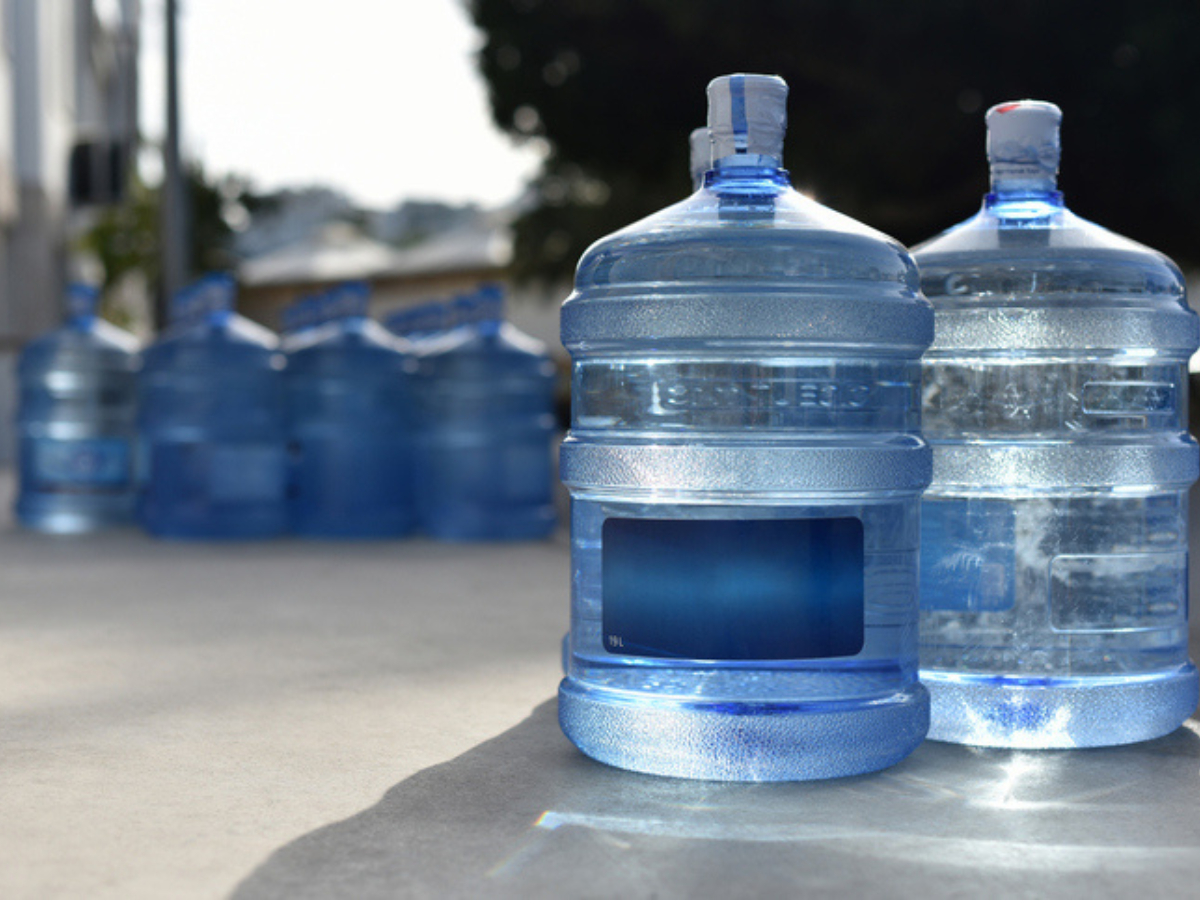 Stored water jugs ready for emergency preparedness at a Cabin and Cottage property.