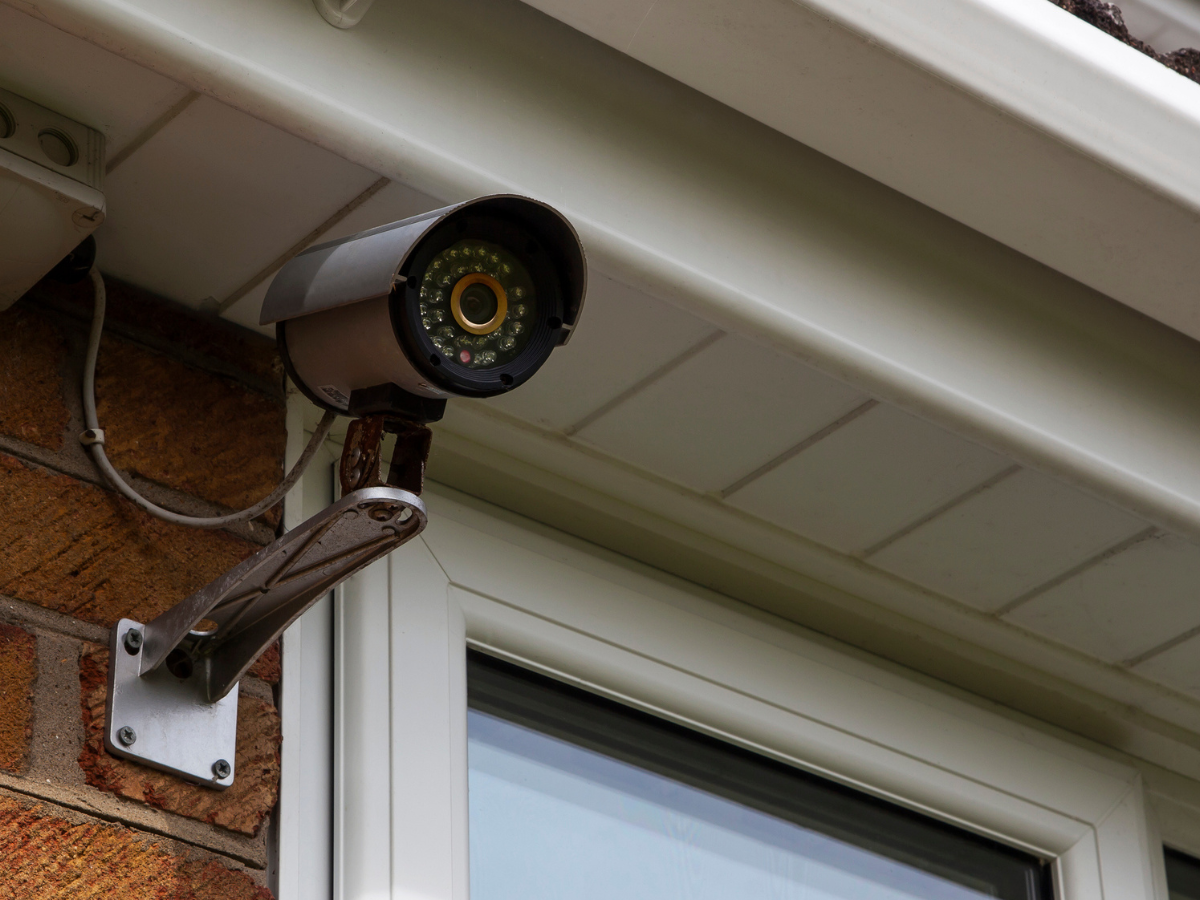 Home security camera installed above a window for protection against Vandalism