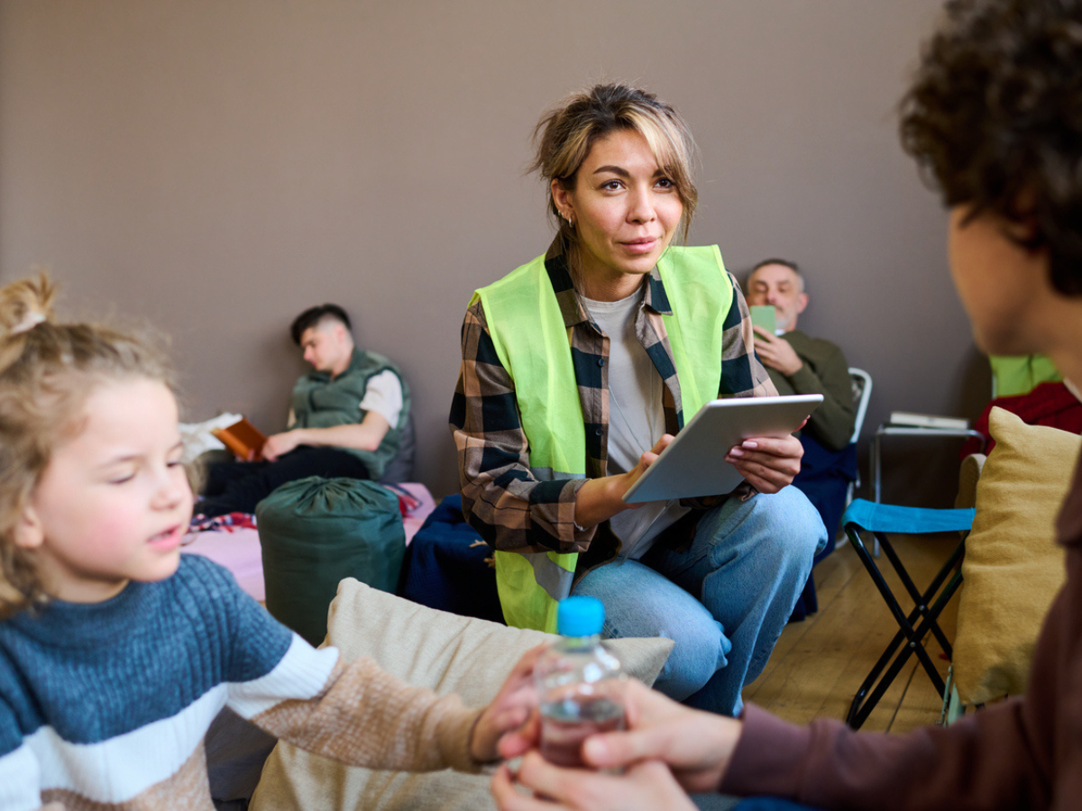 Volunteer talks to displaced families