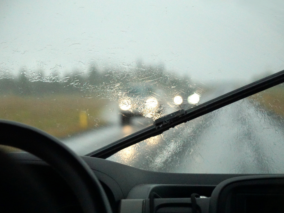 Windshield wipers clearing Rain while driving in low-visibility conditions