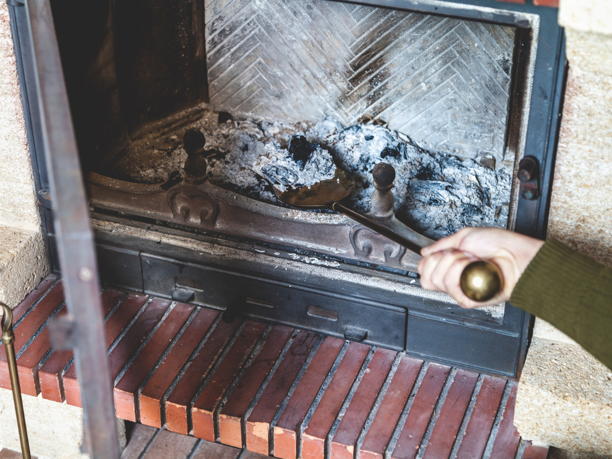 Removing ash buildup from a Fireplace to maintain safe operation