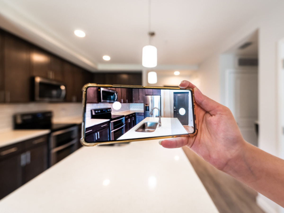 Tenant on a rental tour taking pictures of the suite