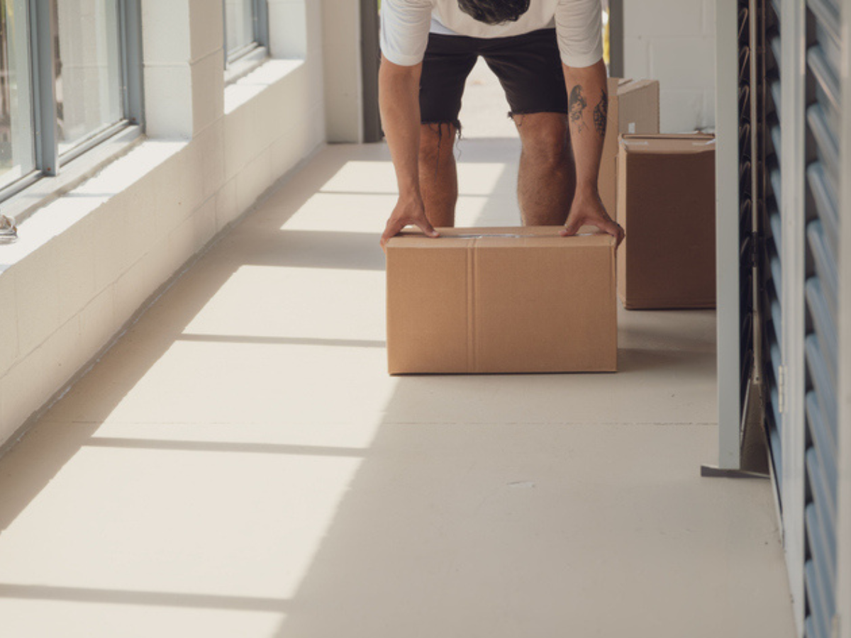 Man moving into a condo with condo insurance with Sandbox
