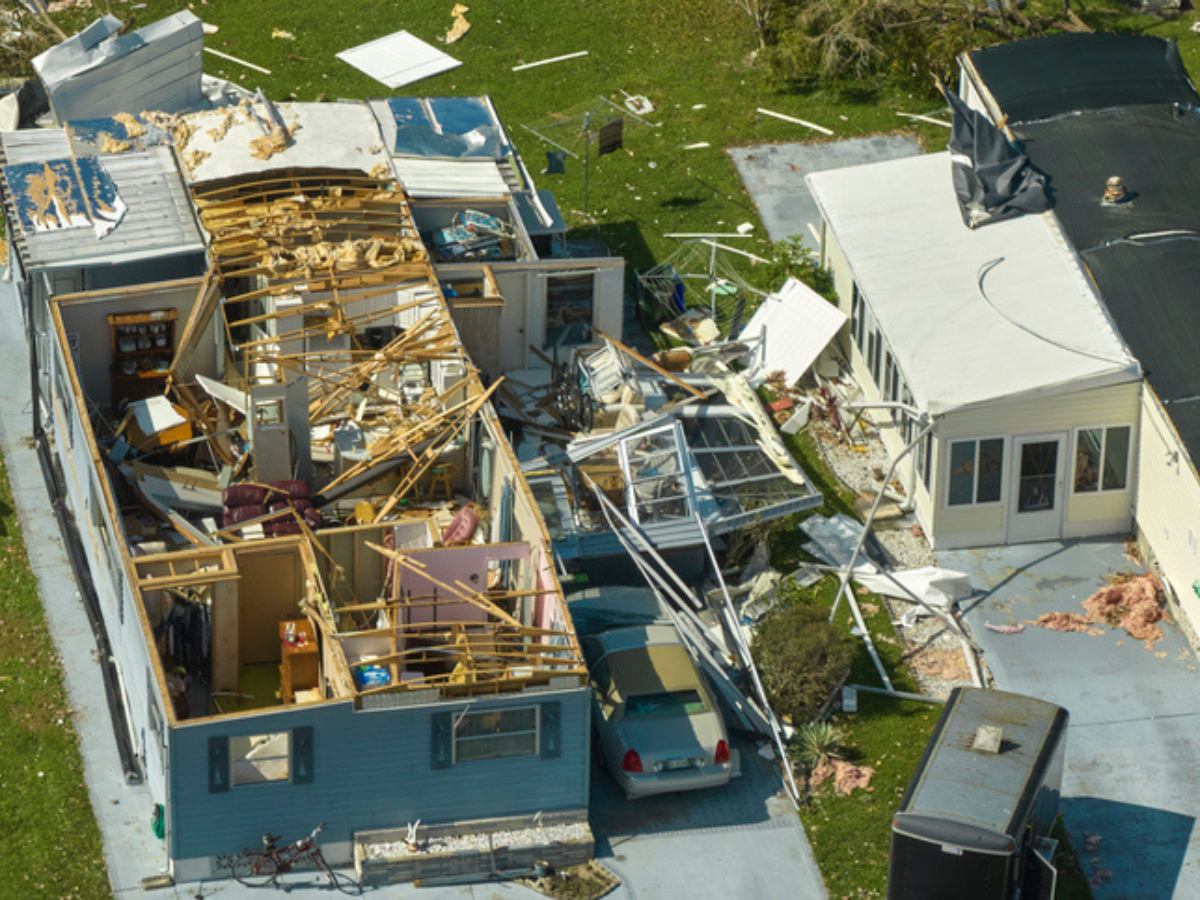 Destroyed house roof after a natural disaster, highlighting property loss and business insurance needs. 