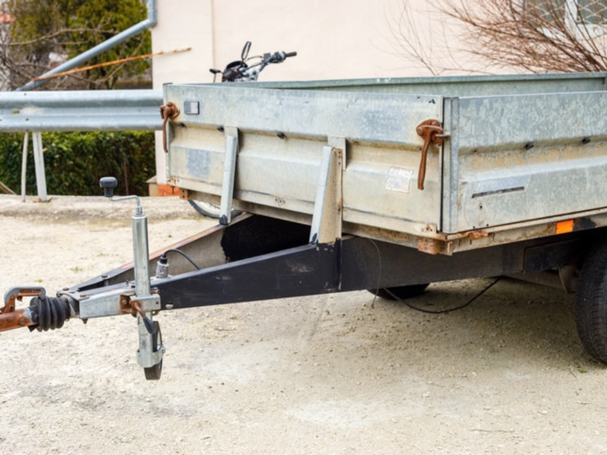 Close-up of a trailer tongue and hitch mechanism, emphasizing the importance of mechanical coverage in utility trailer insurance.