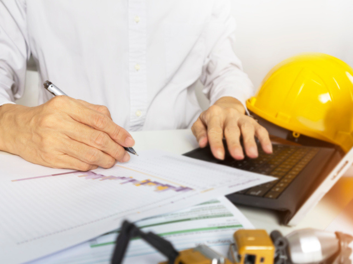 Business owner calculating contractor liability insurance premiums in Western Canada