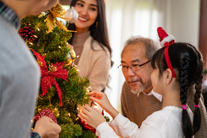 Decorating a christmas tree in a home