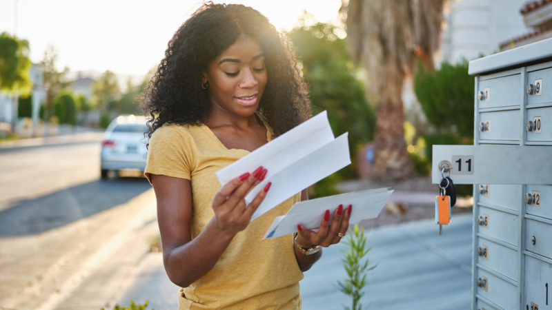 Girl checking mail and receiving a cheque