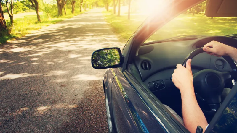 car driving in spring time with sandbox mutual insurance