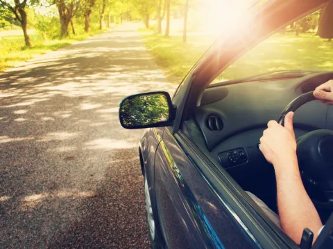 car driving in spring time with sandbox mutual insurance