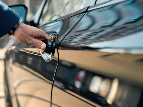 business man opening commercial vehicle with sandbox coverage