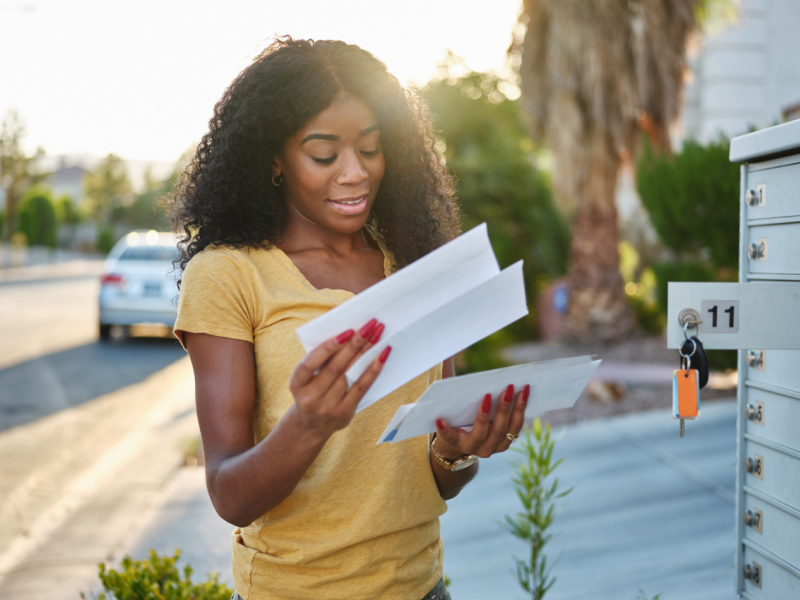 Girl checking mail and receiving a cheque