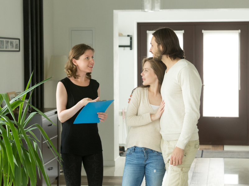 Landlord walking tenants through new house